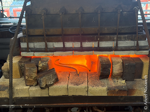 The firebricks have been opened enough for an entire bent tentacle to be in the forge